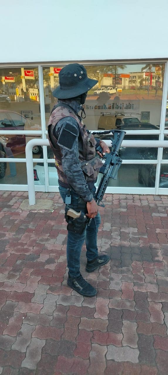 Armed officer patrolling a storefront
