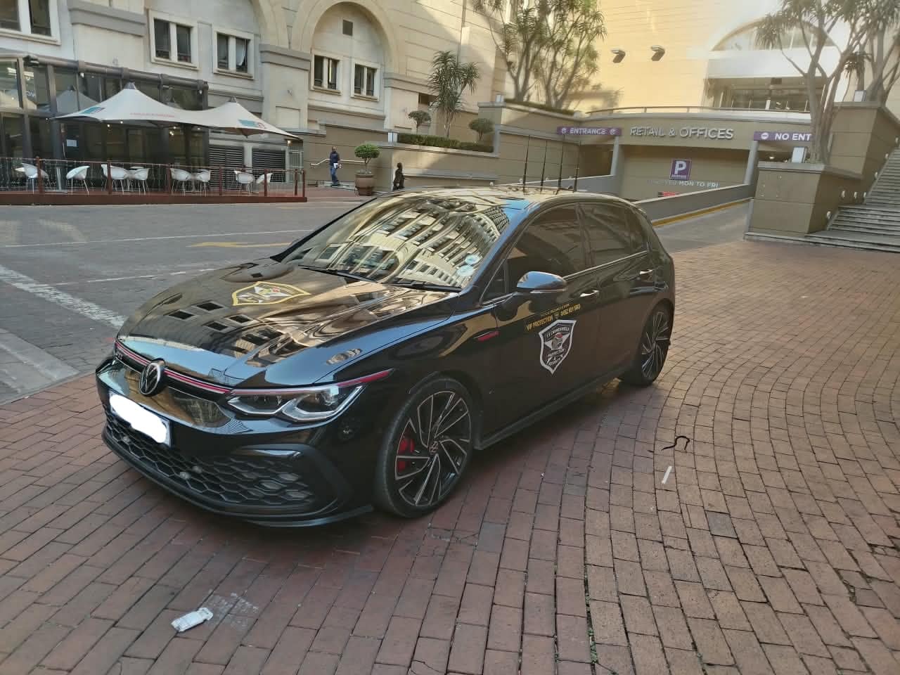 Golf GTI escort vehicle at a hotel forecourt