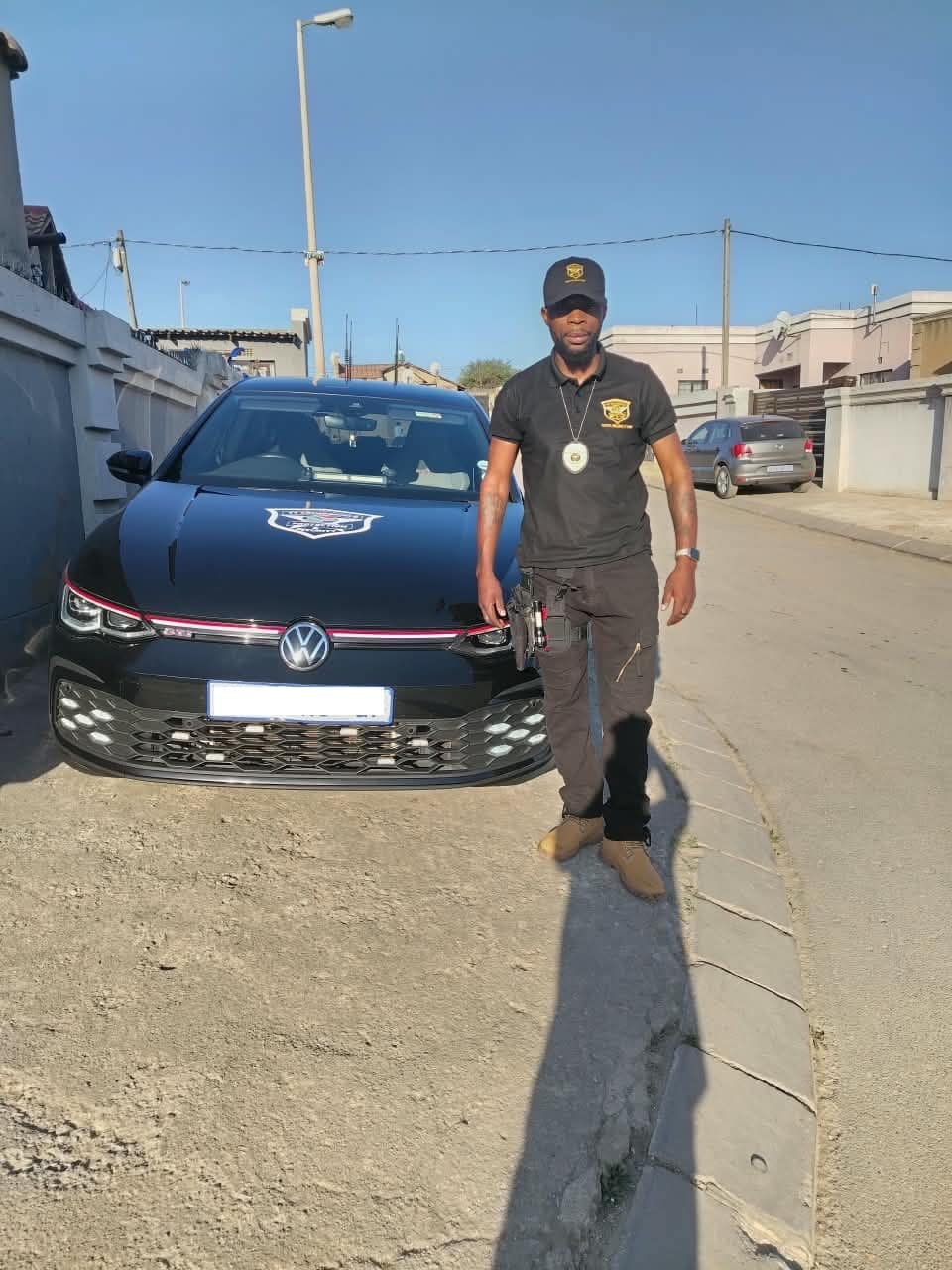 Close protection officer with the escort vehicle