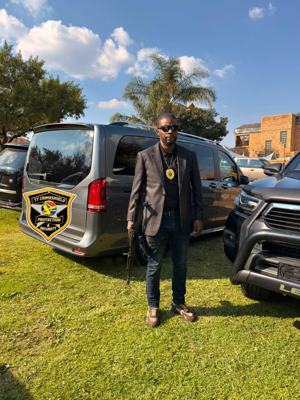 Suited close protection officer with the vehicle group at a function